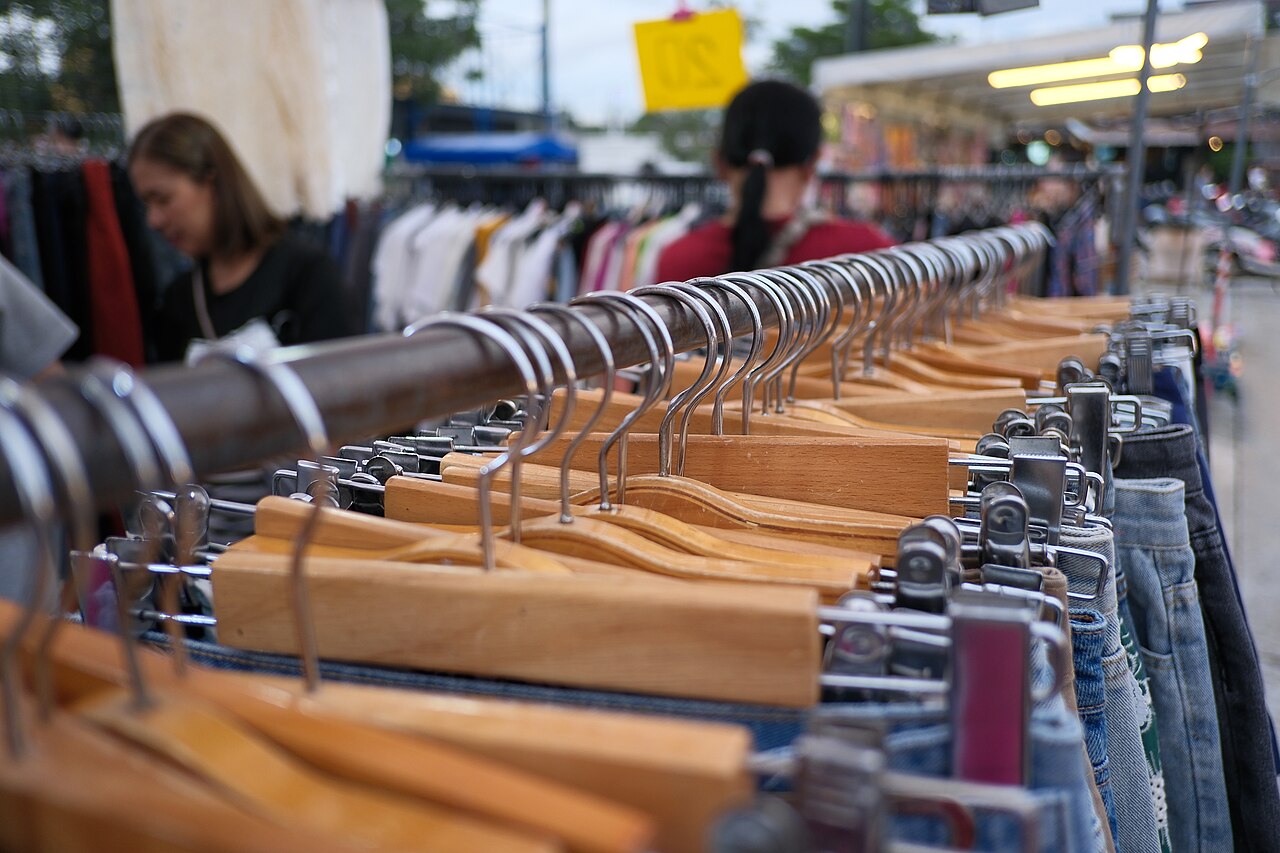 Denim bib overalls on retail rack, front view