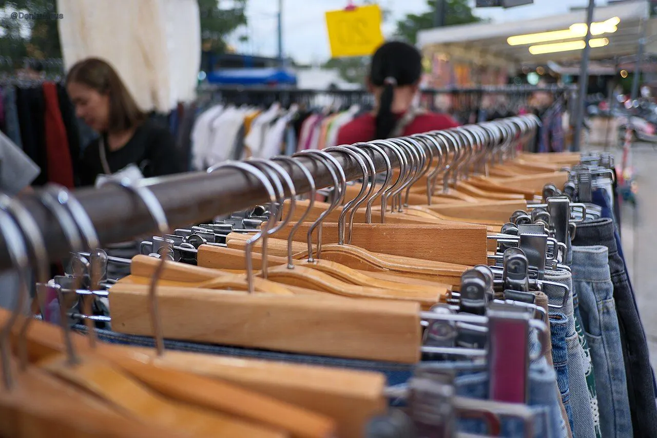 Denim bib overalls on retail rack, front view
